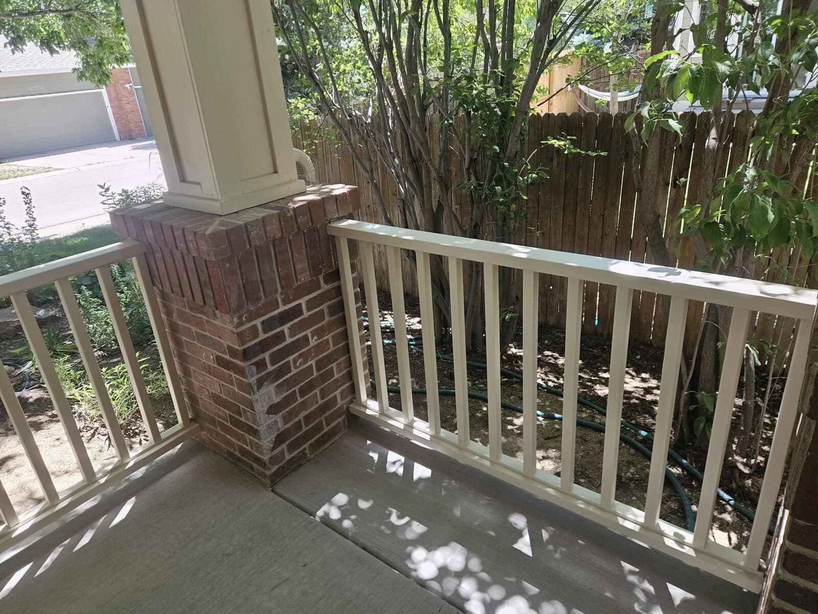 Covered porch with brick column and railings