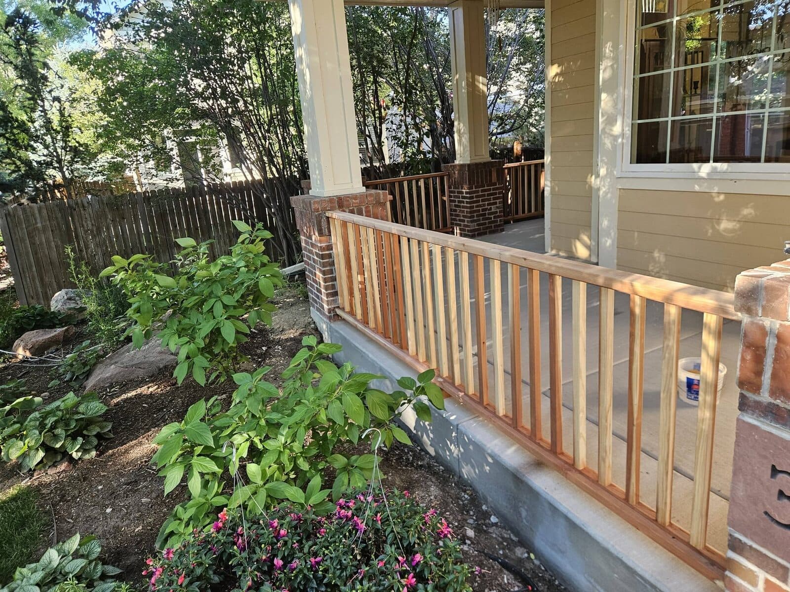 Wooden deck railing with landscaping